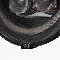 Close-up of an AlphaRex USA NOVA-Series LED Projector Headlight in black for the 2018-2023 Jeep Wrangler JL and Gladiator JT (SKU: 880868), showcasing its intricate design. The headlight features multiple reflective and transparent elements, with detailed textures that highlight precision engineering and contemporary automotive style.