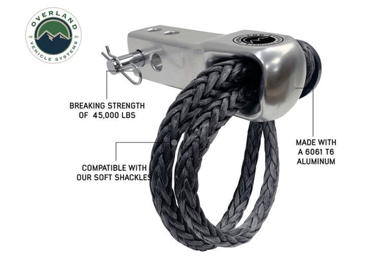 An Overland Vehicle Systems ALUMINUM RECEIVER MOUNT FOR SOFT SHACKLE is shown. It has a breaking strength of 45,000 lbs for secure towing and is constructed with 6061 T6 aluminum. The Overland Vehicle Systems logo is visible in the top left corner.