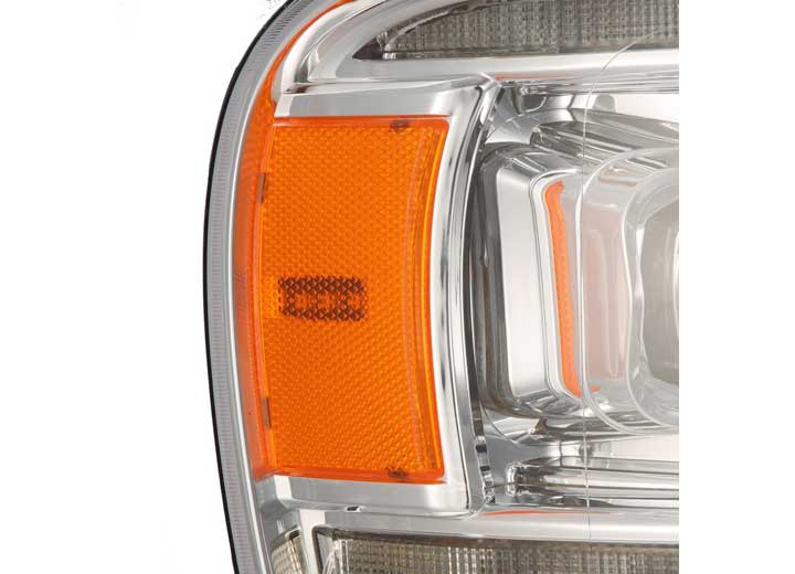 Close-up of the AlphaRex USA RAM 1500/2500/3500 2002-2005/2003-2005 Nova-Series LED Projector Headlight - Alpha Black, featuring a prominent orange reflector on the side. The clear lens and surrounding chrome detailing showcase the intricate design, ensuring enhanced visibility.