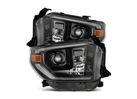 The AlphaRex USA Tundra 14-21 LED Projector Headlights with Sequential Signal & DRL are showcased in the image. These headlights have clear lenses integrated with LED daytime running lights and a main lens housed in a striking black casing, featuring an amber reflector on the side. Designed for modern vehicles, they boast stylish angles and sequential signals for added flair.