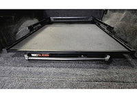 The truck bed is equipped with a BEDSLIDE 1000 CLASSIC BLACK 68IN X 48IN from Bedslide. When extended, the sliding platform reveals its flat surface and sturdy frame. The carpeted interior of the truck bed features the BEDSLIDE 1000 logo prominently displayed on the front edge of the slide mechanism.