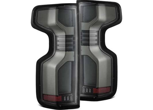 The AlphaRex USA SILVERADO 1500/2500/3500 LED Tail Lights, designed for 2019-2023 Silverado trucks, form an "H" shape when placed together. These modern lights feature sleek dark gray tinted lenses, subtle accents, and red lighting elements at the bottom, arranged symmetrically for improved visibility.