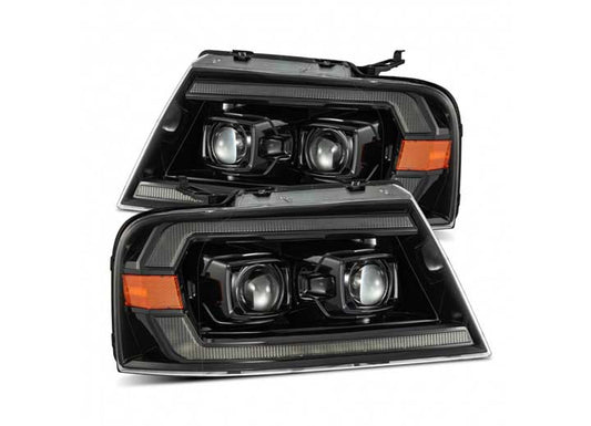 A close-up image of the 04-08 F150/06-08 MARK LT LUXX-Series LED Project Headlights Chrome with Sequential Activation Light and Sequential Signal by AlphaRex USA, featuring sleek black housings integrated with rectangular and circular LED lights, as well as orange indicators. These headlights boast a stylish design with sharp, angular lines.