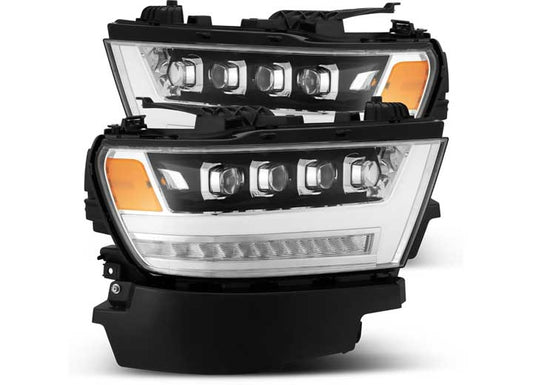 The AlphaRex USA RAM 1500 HD NOVA 20 Series LED Projector Headlights for 2019-2022 models boast a modern, sleek, angular design. Featuring clear lenses, multiple light sections, and an efficient LED illumination strip, these headlights also come with black housings and orange turn signal sections on the outer edges.