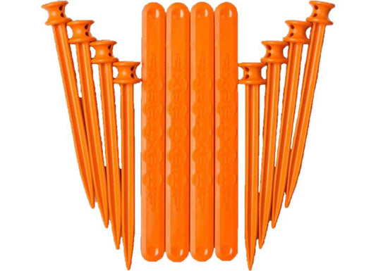 A setup of vivid orange plastic tent stakes and straight alignment sticks, evocative of the MAXTRAX FIXING & LINKING KIT by MAXTRAX, arranged on a white background. The stakes feature a hook end and pointed tip, while the alignment sticks are flat with grooved designs—ideal for off-road escapades.