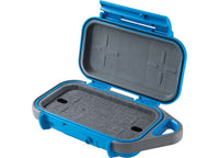 A Pelican Go Case G40 in Durable Surf Blue/Grey is shown open. The top and bottom interiors are padded with foam for cushioning. The case features two small cutout sections, impact-resistant materials, waterproof protection, and a side handle for portability.