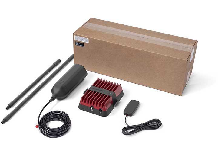 A boxed weBoost Drive Reach OTR Fleet Signal Booster Kit includes an antenna, modem, power cable, and two mounting brackets. The antenna is large and cylindrical, the modem features a red heatsink, and the peripherals are neatly coiled or placed. Designed for fleet vehicles, this setup appears ready for installation.